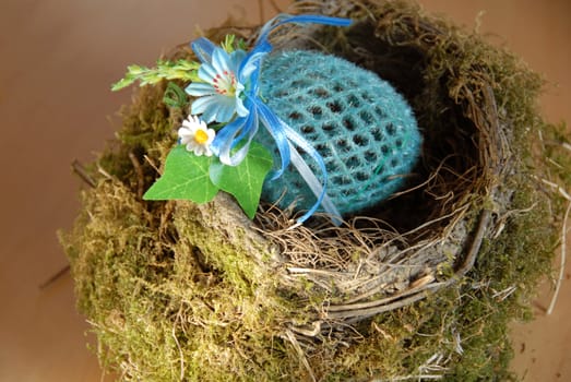 easter decorative artificial egg in natural bird nest
