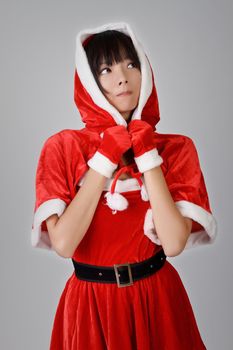 Christmas girl of Asian looking over gray studio background.