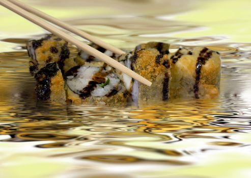 Appetizing rolls watered with soya sauce. A photo close up.