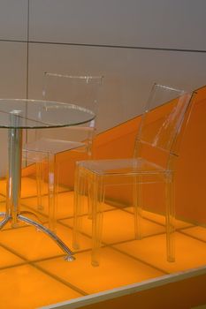 Table for negotiations, with plastic and transparent chairs.