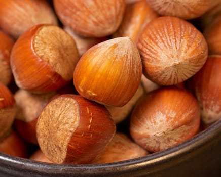 Closeup of fresh unshelled hazeluts in a bowl