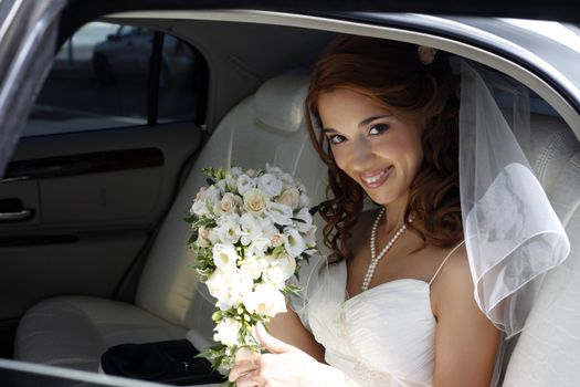 The beautiful bride in the automobile