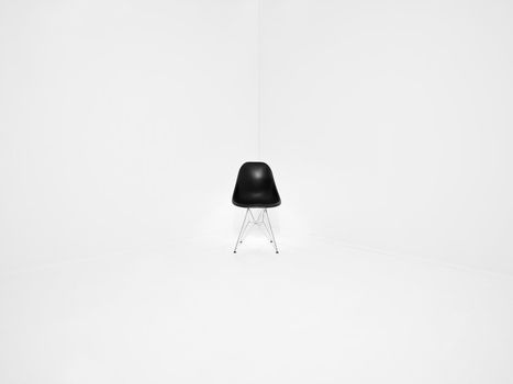Retro chair in a corner of a white room