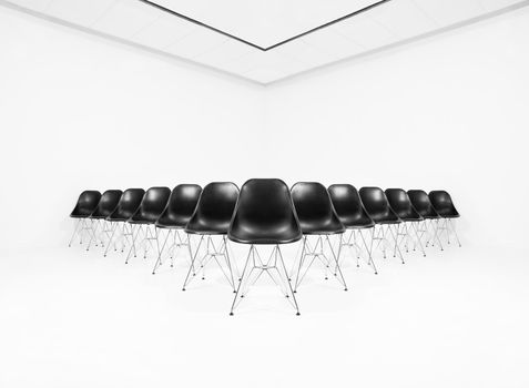 Black chairs isolated in a white room