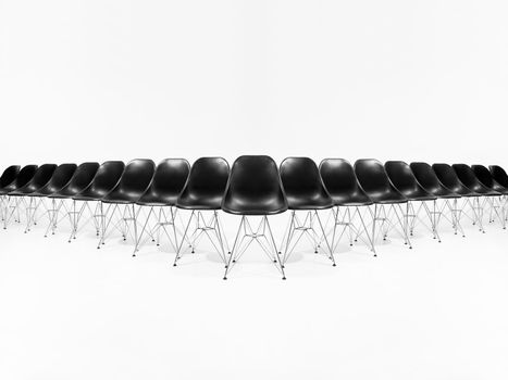 Formation of black chairs isolated on white background