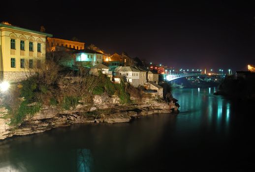 Mostar old town at night with the Luka Bridge above the Neretva river.