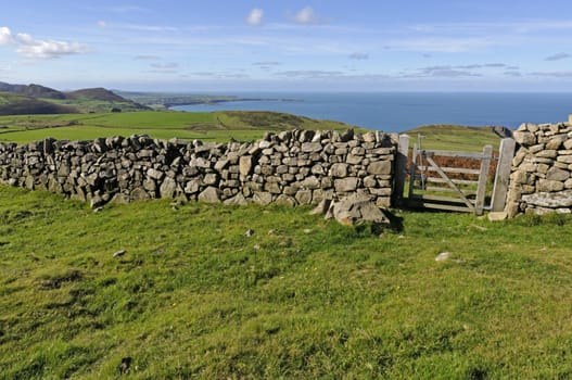 View across farmland on the northern coast of the Llyn Peninsula Wales