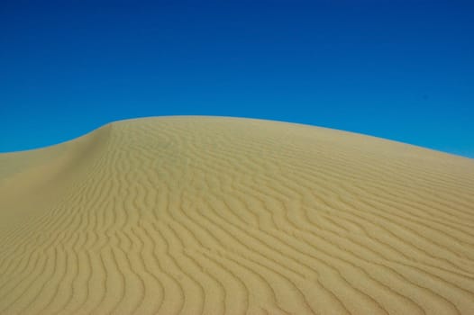Sand dune against the sky in Patagonia, Argentina.