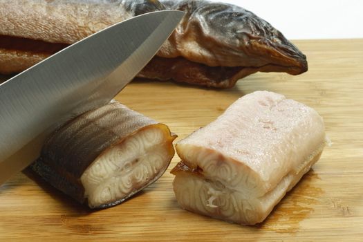 Preparation of smoked eel on a wooden plate