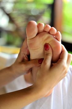 Reflexology foot massage, spa foot treatment
