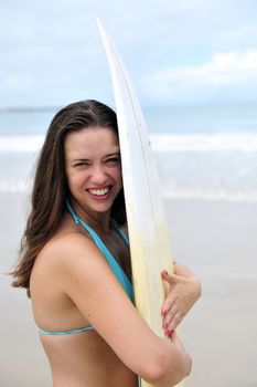 Surf girl holding a board in Brazil
