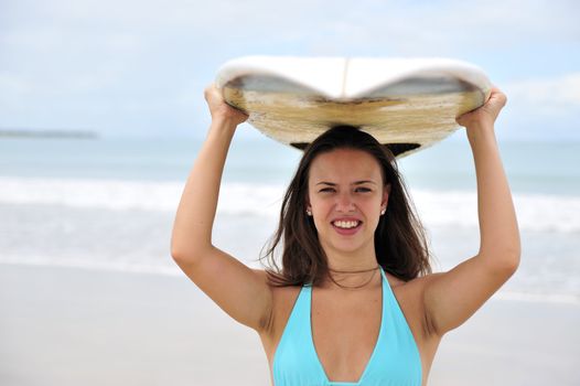 Surf girl holding a board in Brazil
