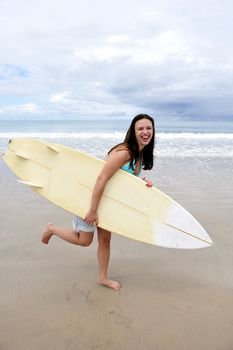 Surf girl holding a board in Brazil
