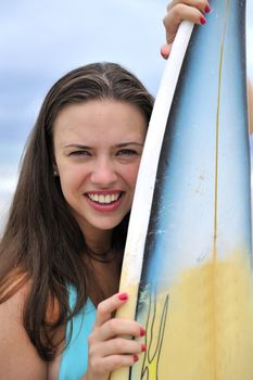 Surf girl holding a board in Brazil

