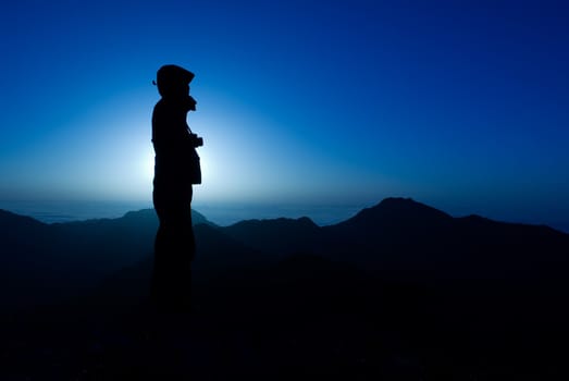 A silhouette of cameraman with golden light in the morning.