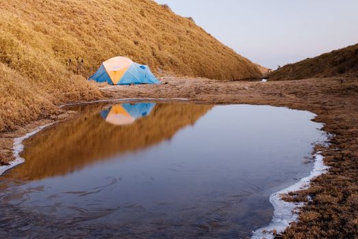 A forzen small tent in cold high moutain lake.