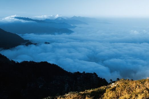 Clouds like sea and waterfall in high mountain.