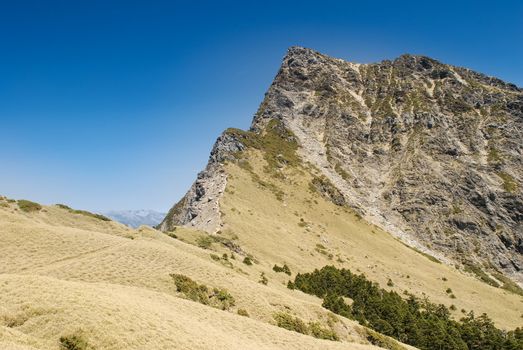 Dangeours and majestic rock peak of high mountain.