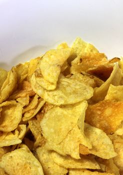 A close-up of a bowl of greasy potato chips.
