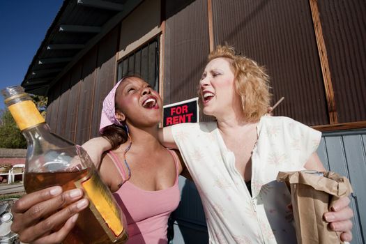 Portrait of two trashy drunk women outdoors