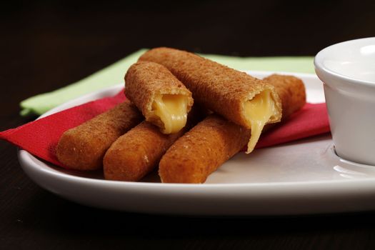 roasted cheese sticks on white plate