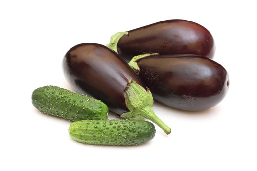 Three eggplant with green cucumbers isolated on white