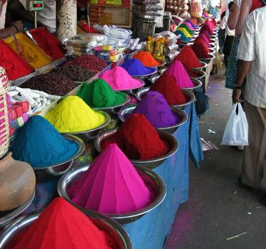 A stall selling multi-coloured dyes for Holi