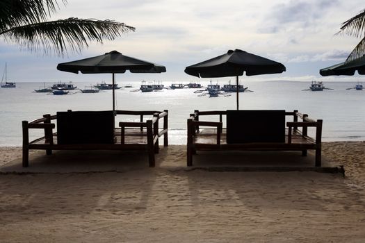 Armchairs for rest on a coast of silent ocean
