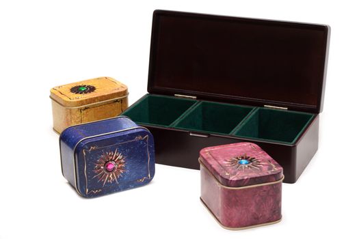 Box with tea, iron packing, decorated stone on white background