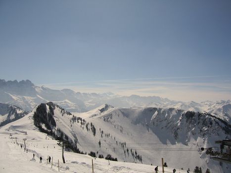 A view of the French Alps featuring a ski Drag lift.