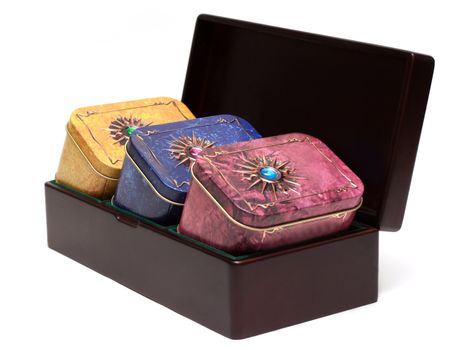 Box with tea, iron packing, decorated stone on white background