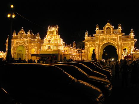 The illuminated gate of the Mysore Palace, reflected in Car windows