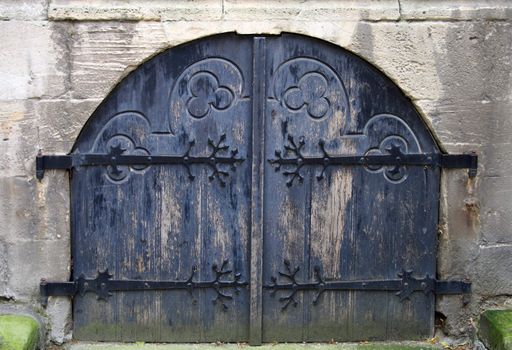 Ancient dark blue church gate, are locked from within.