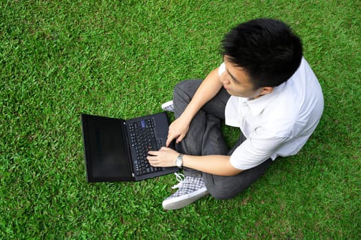 asian man using computer outdoor