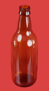 Brown glasses bottle on the red background