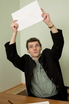 Director on a workplace with a graph in a hand