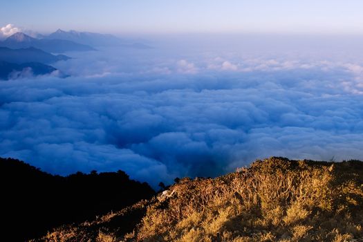 Clouds like sea and waterfall in high mountain.