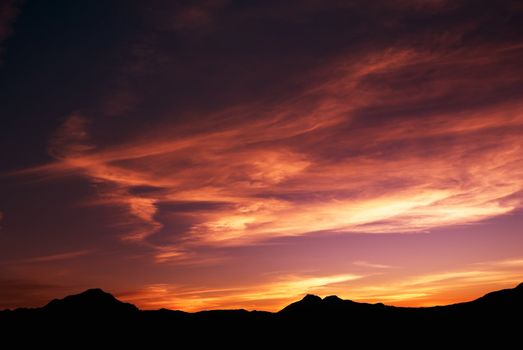 high mountain silhouette with beautiful colorful clouds.