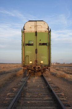 old tall stock rail car for livestock transportation or train end on a sidetrack in Colorado farmland