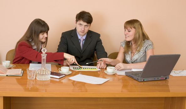 Business team sits at the big table