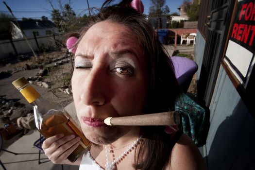 Hispanic woman in front of house with messy yard