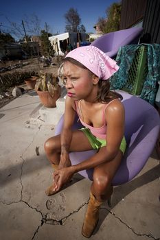 Black woman in front of house with messy yard