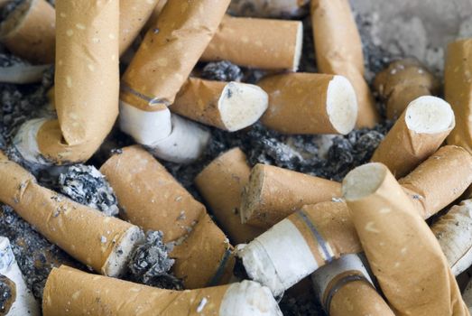 An ashtray full of ash and cigarette butts