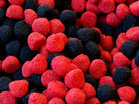 Macro of black and red candy fruits