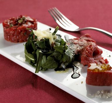carpaccio and arugula on plate