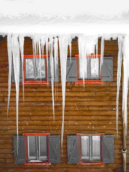 Wooden windows with  stalactites of ice