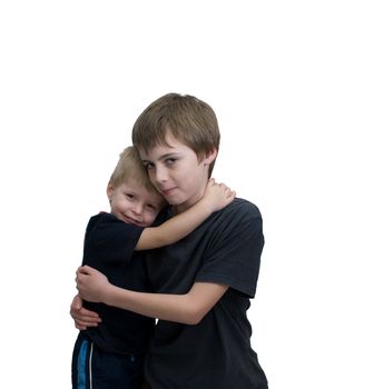 Two brothers hug affectionetly.