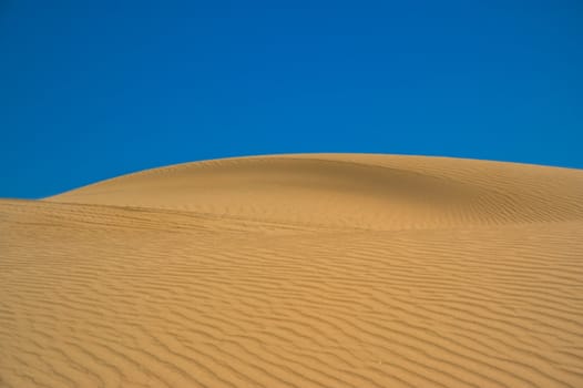 Sand dune against the sky in Patagonia, Argentina.