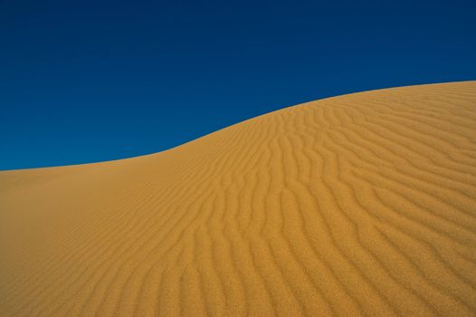 Sand dune against the sky in Patagonia, Argentina.