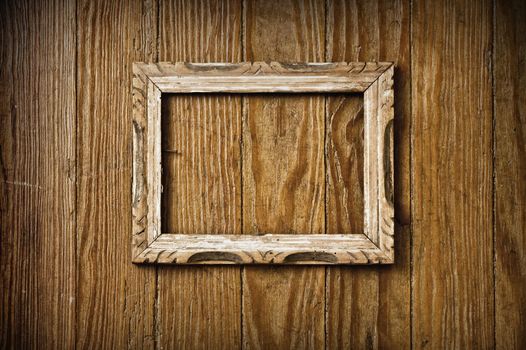 Blank vintage picture frame on a wooden wall.